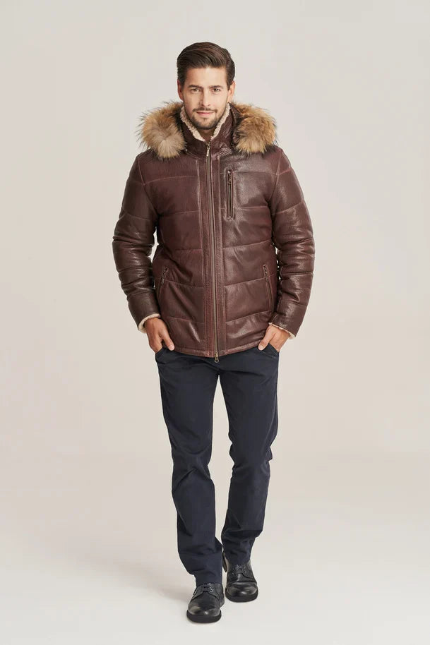 Man wearing a brown leather jacket with fur hood on a beige background